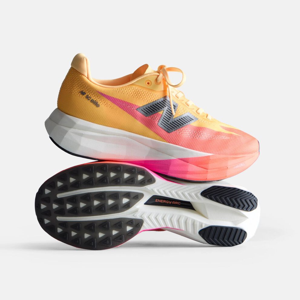 Orange and peach running shoe with a white midsole and black New Balance logo on a white background. 